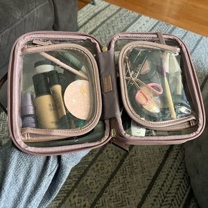 Calpak mauve clear cosmetic case.